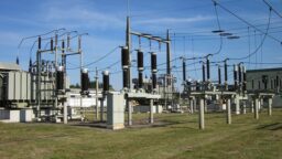 Electricity distribution sub station grass and blue skies